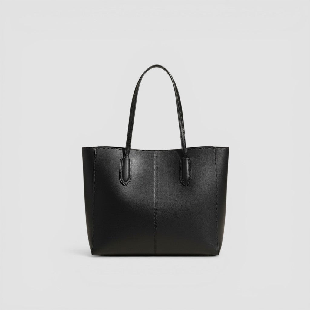 Loceor black smooth faux leather tote bag with long shoulder straps and snap closure. Spacious interior with pocket.