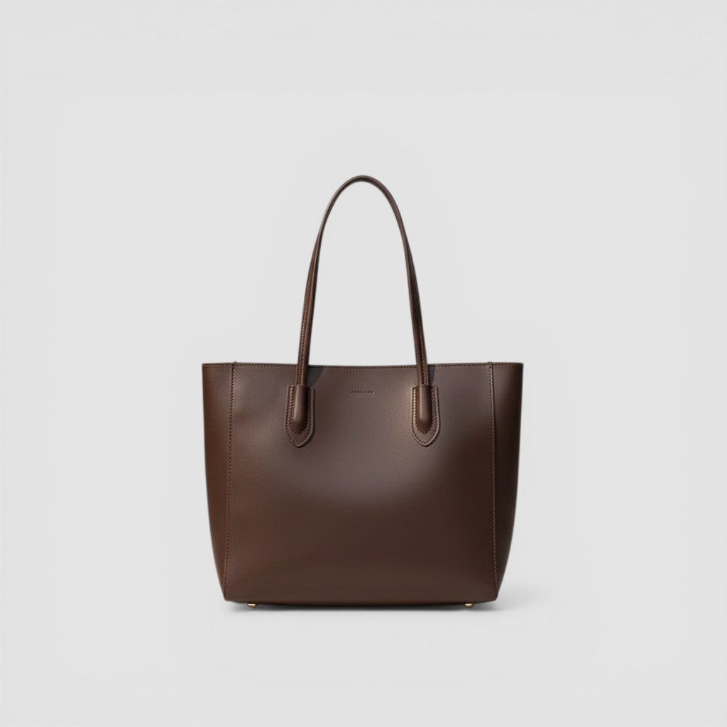 Loceor large brown smooth faux leather tote bag with long shoulder straps and interior pocket.