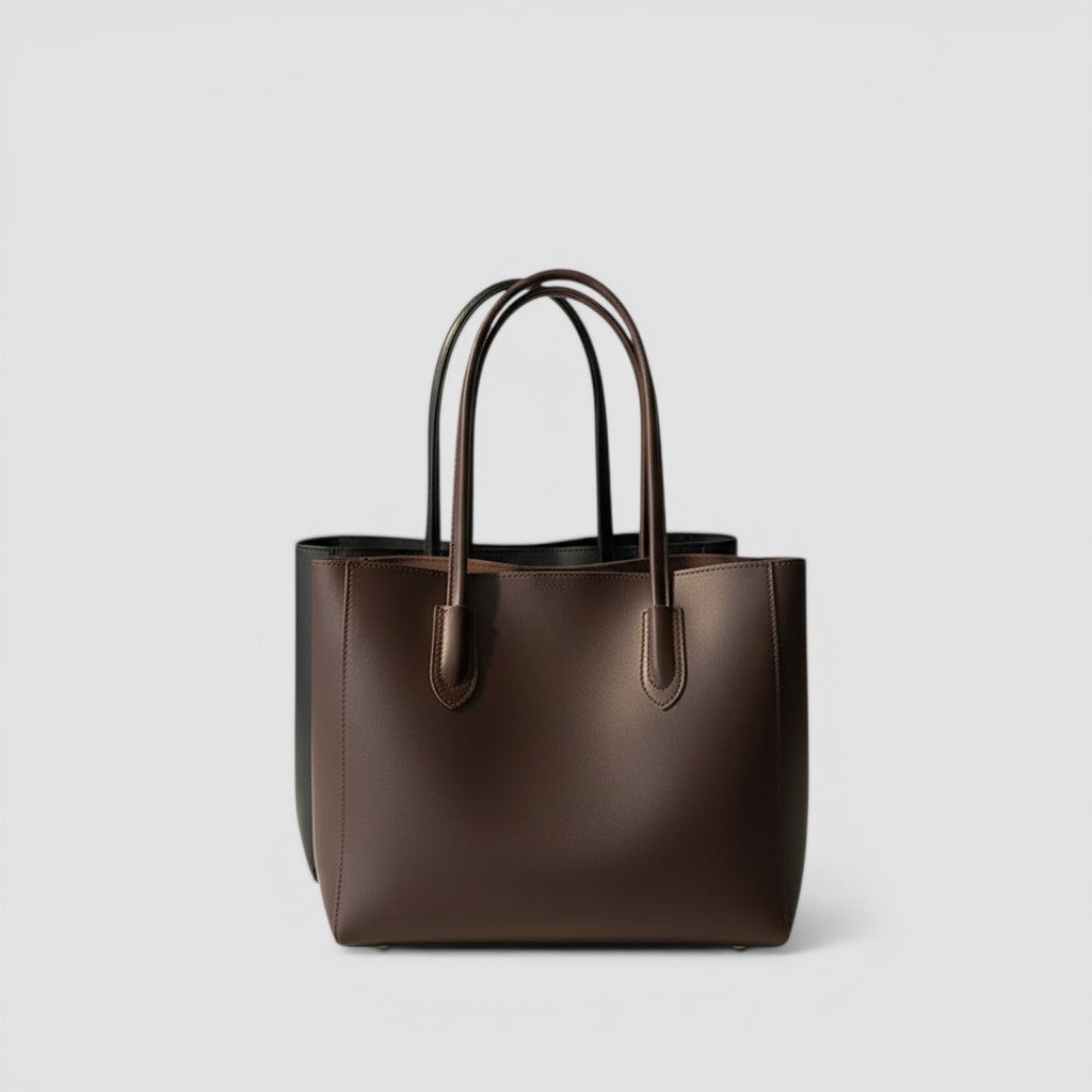 Loceor large brown smooth leather tote bag with long shoulder straps and snap closure. Spacious interior with pocket.